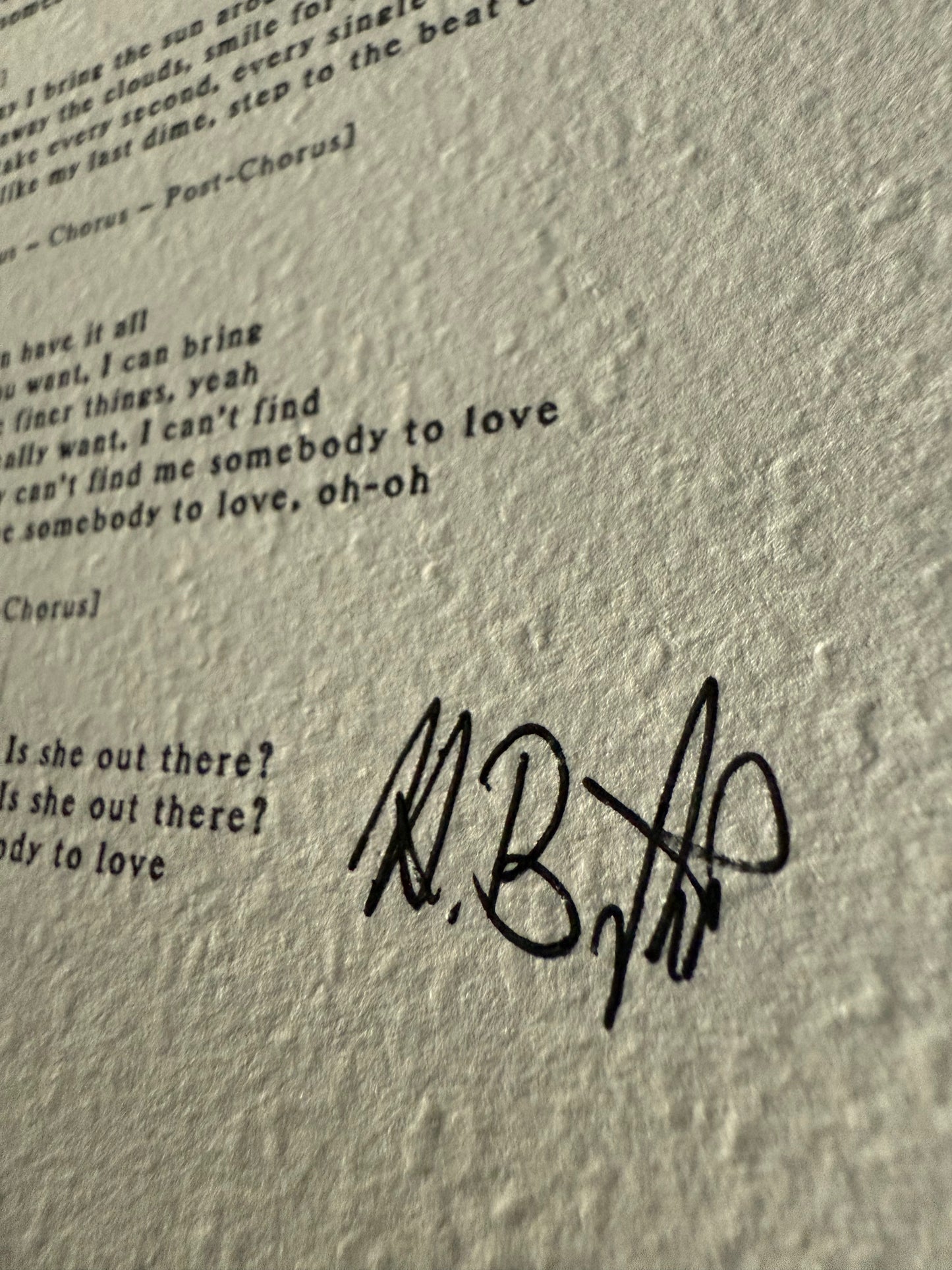 Text with a signature on a textured gray background