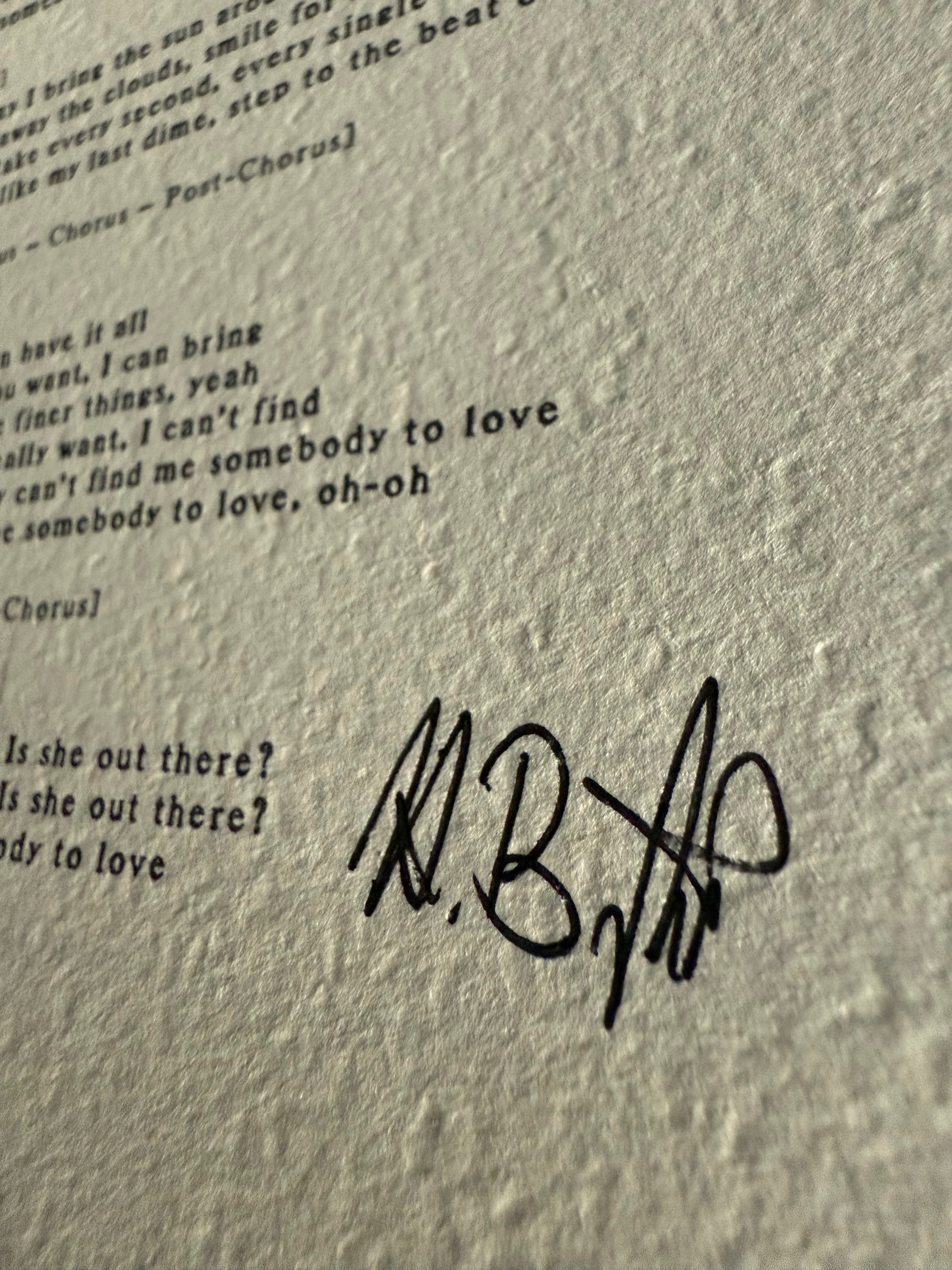 Text with a signature on a textured gray background